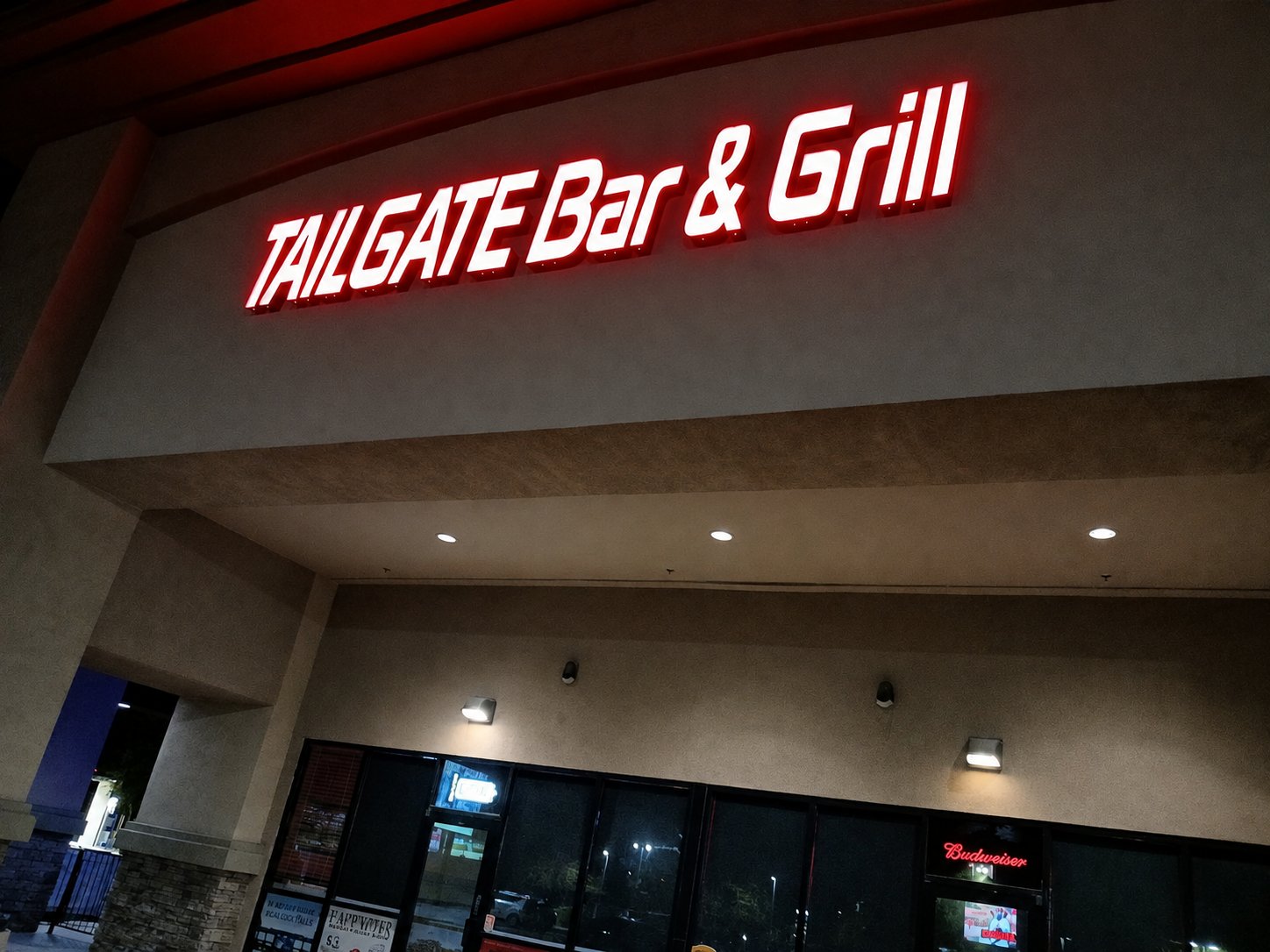 The Tailgate Bar & Grill neon glowing at night